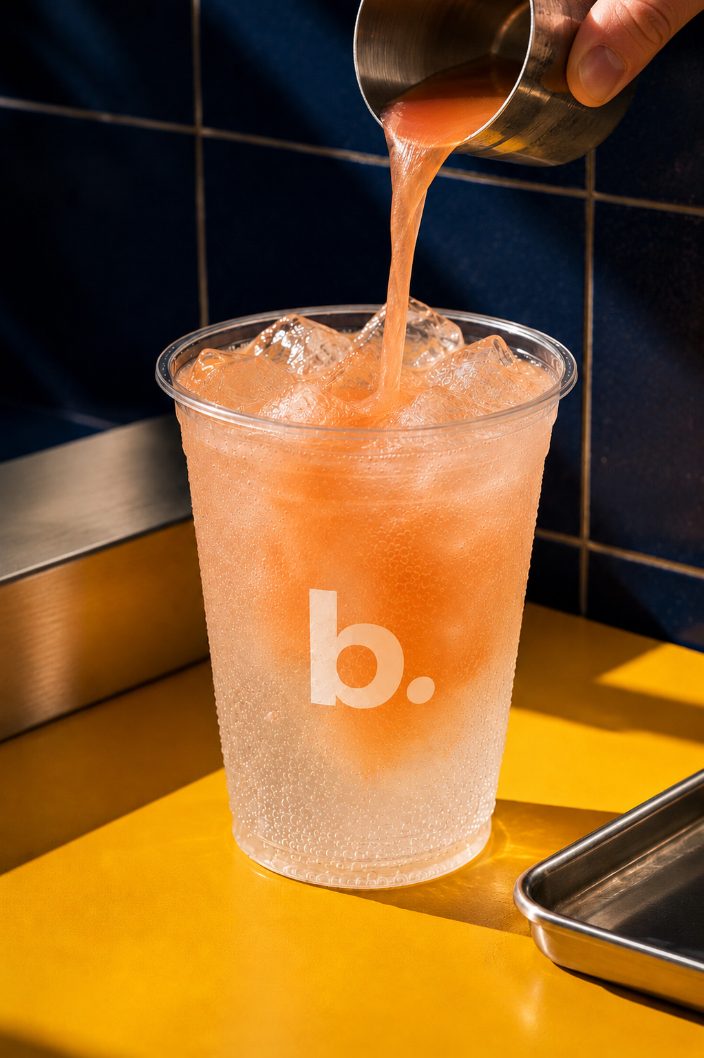 Peach syrup pouring into a blenz briza